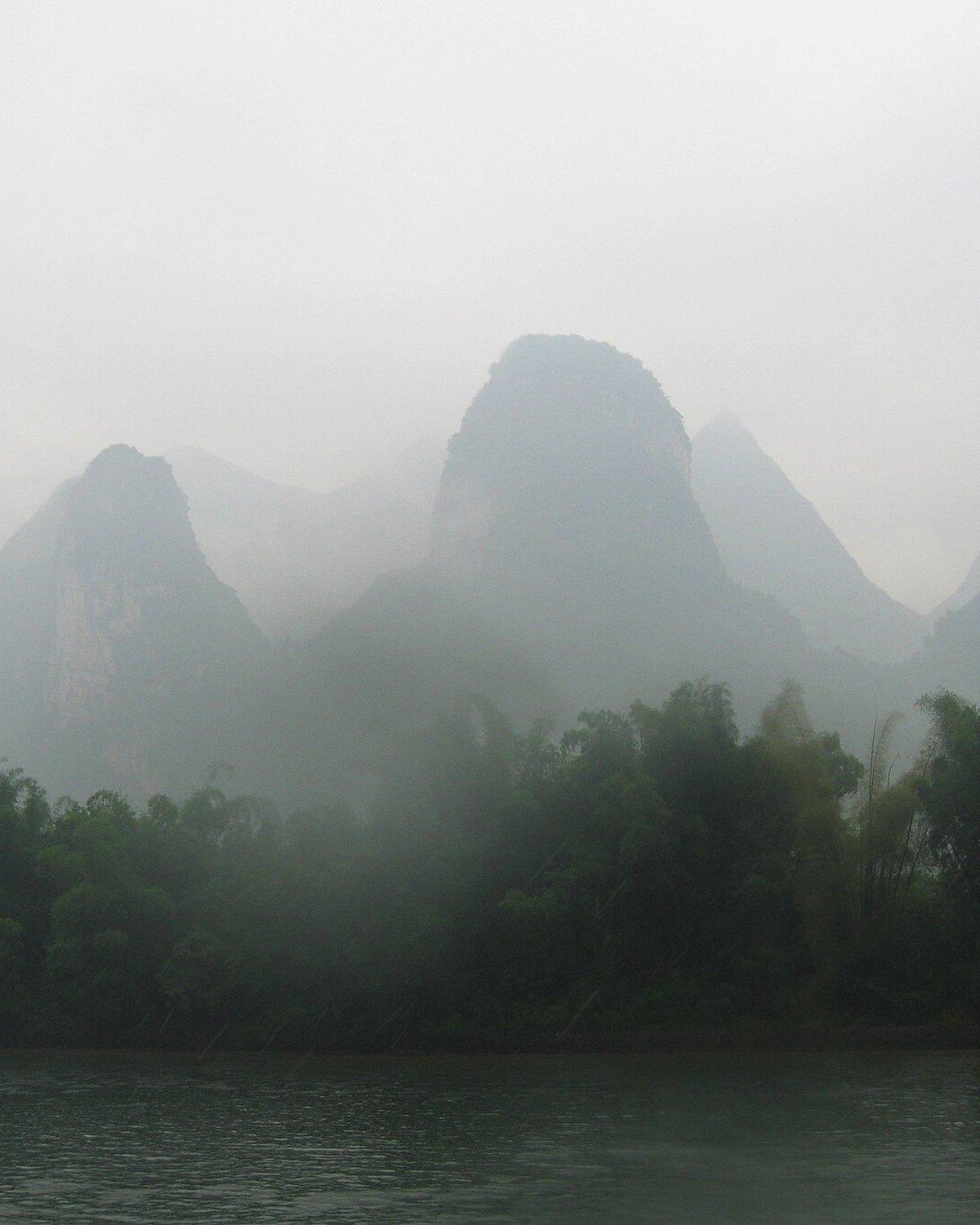 Karst hills in mist above the Li River near Guilin