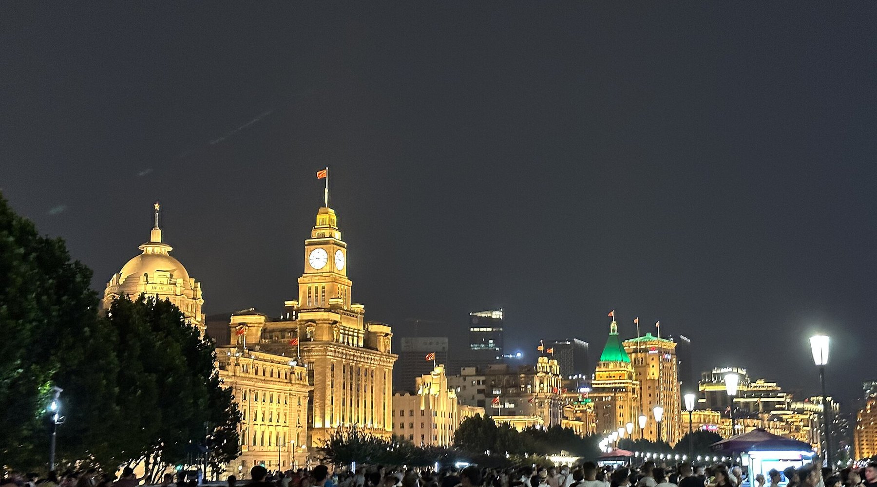 The Shanghai skyline and the Bund lit up at night above the Huangpu River